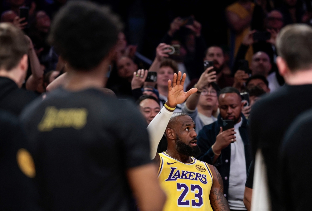 LeBron James #23 of the Los Angeles Lakers reacts after making a 3-point basket to score his 50,002 NBA regular season and playoff career points during the first half against the New Orleans Pelicans. — AFP pic