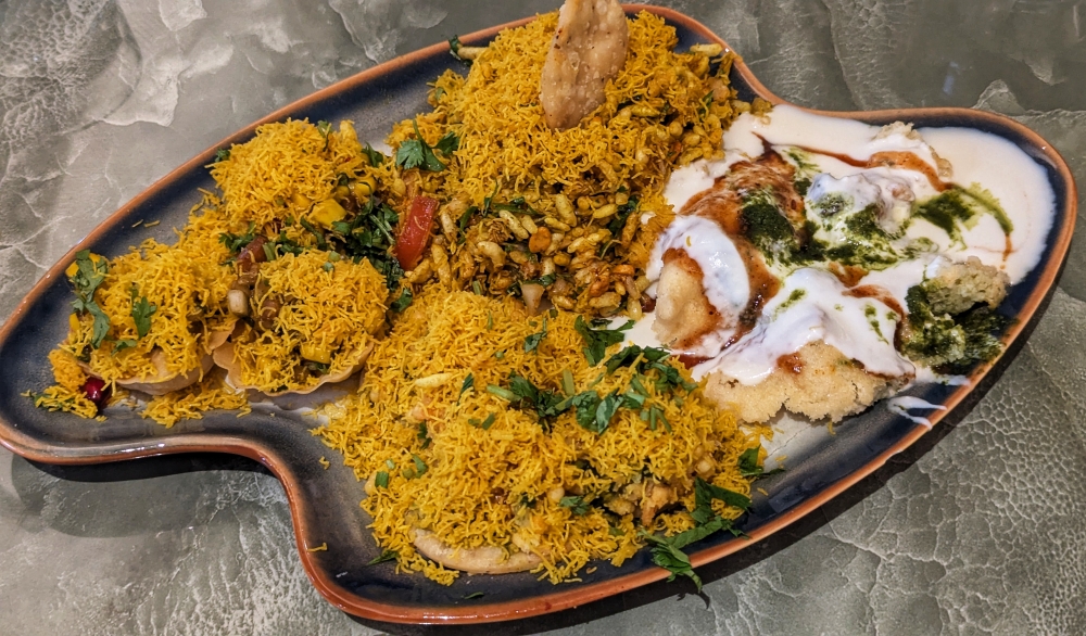 The KP Chaat Platter features four types of ‘chaat’ on one plate, including ‘bhel puri’, ‘dahi wada’, ‘sev puri’ and crispy corn baskets (clockwise) — Picture by Ethan Lau