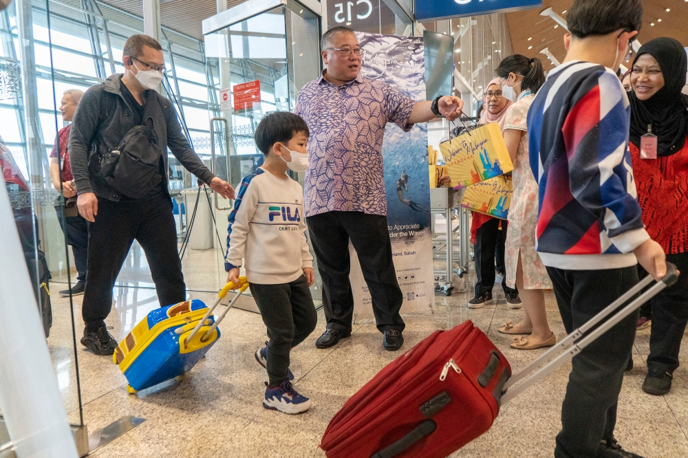 File picture of Tourism, Arts and Culture Minister Datuk Seri Tiong King Sing greeting China tourists during the tourist arrival reception ceremony in conjunction with the 2023 Chinese New Year Festival in KLIA, Sepang, January 22, 2023. — Picture by Shafwan Zaidon