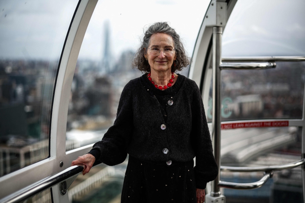 British architect of the London Eye Julia Barfield, poses for a portrait inside a London Eye capsule, in London on February 25, 2025. The initial priority was finding a breathtaking way to see the city, she told AFP in an interview inside one of the giant ferris wheel's 32 glass pods, now drifting against the backdrop of the Houses of Parliament. — AFP pic