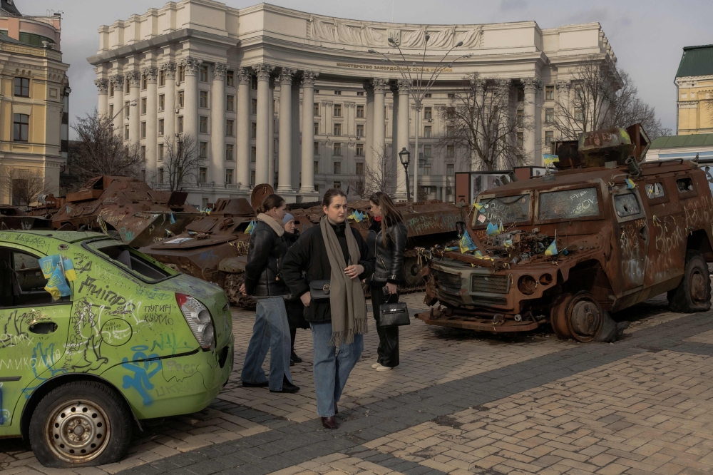 People walk by destroyed Russian military vehicles displayed in downtown Kyiv, Ukraine on March 4, 2025. — AFP pic