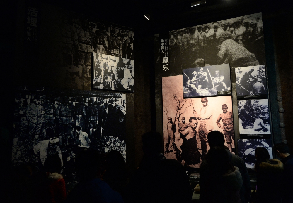 Chinese tourists view photos of Japanese war crimes at the Nanjing Massacre Memorial Museum in Nanjing on February 12, 2014. A Frenchman’s donation of vintage conflict photographs to China offers insight into the 1930-1940s Sino-Japanese war — even if some images are not the unique family heirlooms he believed them to be. — AFP pic