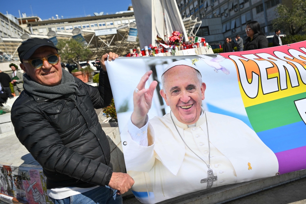 People hold a banner reading 