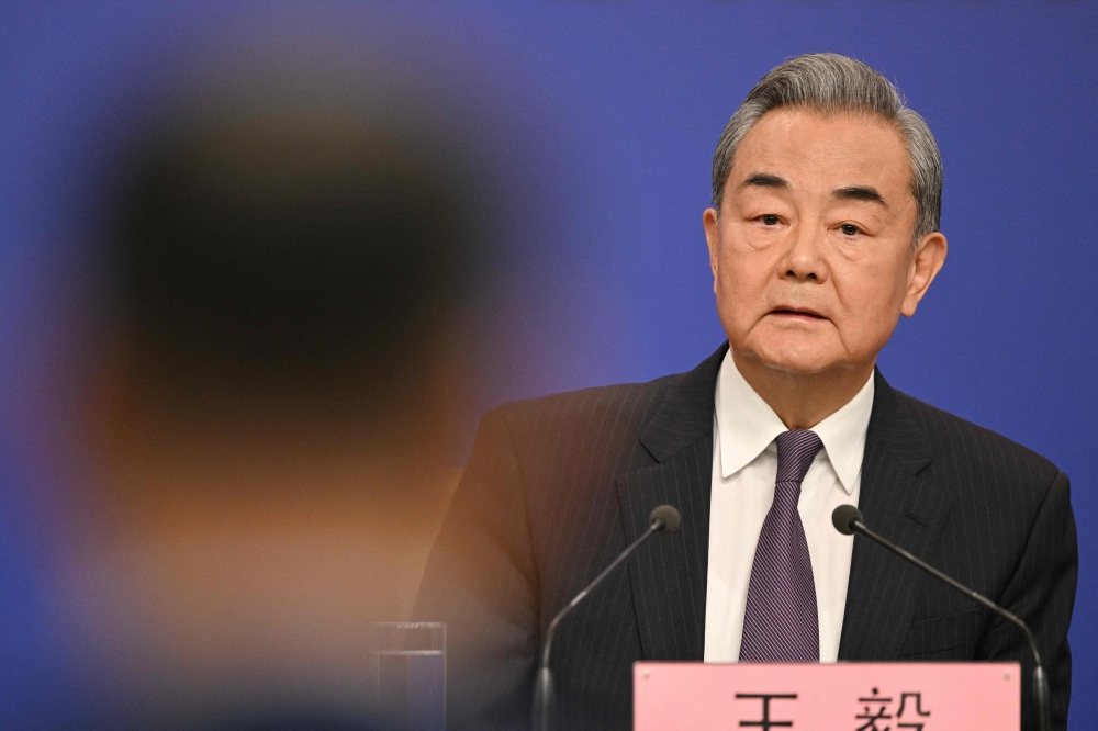 China's Foreign Minister Wang Yi takes questions at a press conference during the ongoing National People's Congress (NPC) in Beijing on March 7, 2025. — AFP pic