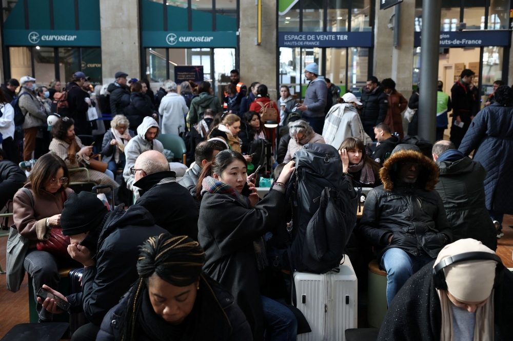 Passengers wait inside the departure hall as traffic has been disrupted at the Gare du Nord train station following the discovery of an unexploded bomb dating back to World War Two 2.5km from the train station, in the middle of the train tracks in Paris March 7, 2025. — Reuters pic 