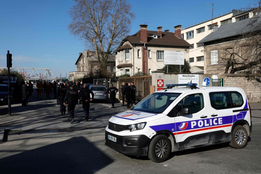 French police officers block the access to the SNCF's freight area in Saint-Denis, northern suburb of Paris on March 7, 2025, following the discovery of a World War II bomb. — AFP pic
