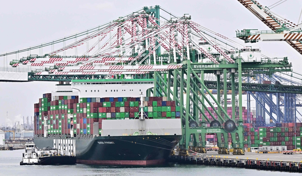 A cargo ship full of  containers docks at the Port of Los Angeles on March 5, 2025, in San Pedro, California, one day after US President Donald Trump initiated sweeping tariffs on Canada, Mexico and China. From Monday, Beijing will impose on top of existing tariffs an additional 10-15 per cent on several US farm products. — AFP pic