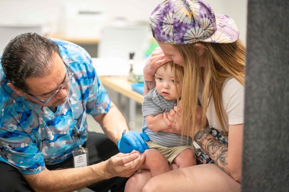 One-year-old River Jacobs getting his MMR vaccine in Texas. — AFP pic