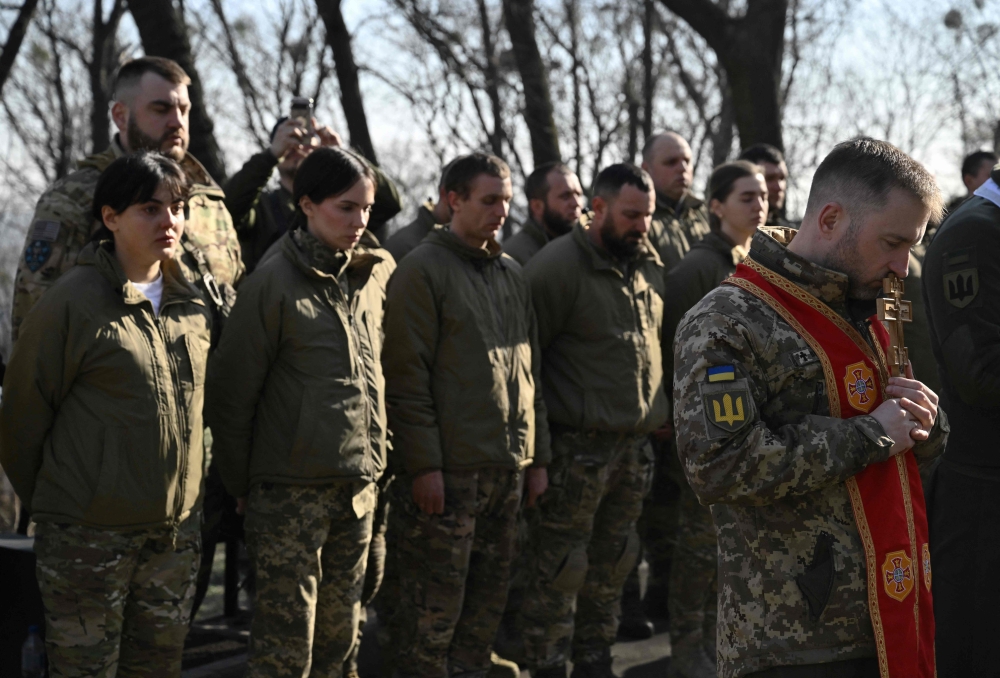 At a swearing in ceremony for Ukrainian fighters formally joining the Da Vinci Wolves battalion at the memorial of the battalion’s former leader, Dmytro Kotsiubailo in Kyiv on March 7, 2025. — AFP pic