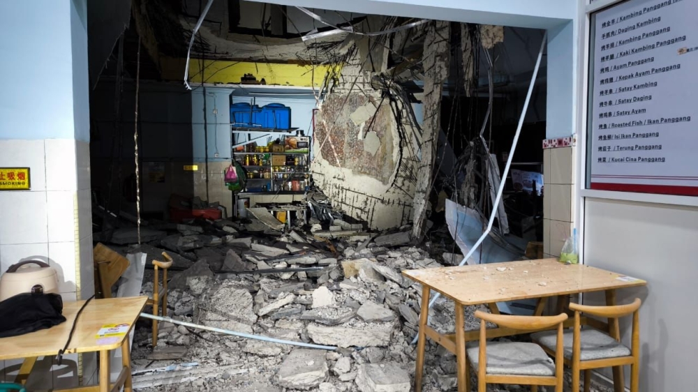 A woman injured from debris from the shoplot was rushed to the Queen Elizabeth Hospital in Kota Kinabalu. — Borneo Post pic