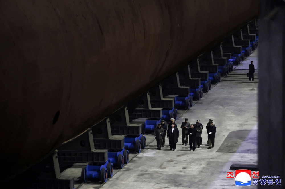 This undated picture released from North Korea’s official Korean Central News Agency (KCNA) via KNS on March 8, 2025 shows North Korean leader Kim Jong Un (front C) inspecting a shipbuilding project at a major shipyard at an undisclosed location in North Korea. — AFP pic/KCNA via KNS