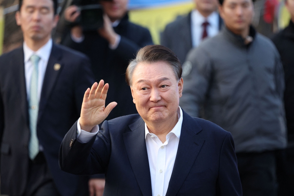 South Korean President Yoon Suk-yeol left a detention centre in Seoul on Saturday, after prosecutors decided not to appeal a court decision to cancel the arrest warrant of the impeached leader. — Reuters pic