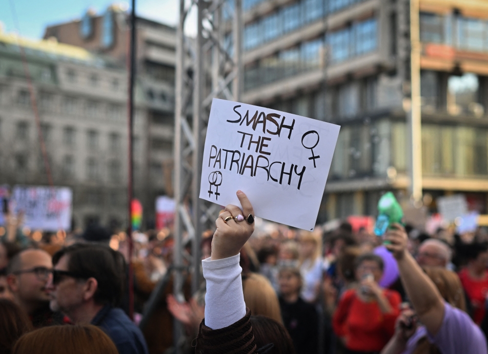 Protesters hold placards as they gather in Republic Square in Belgrade on March 8, 2025, during a rally held to mark International Women’s Day. — AFP pic 