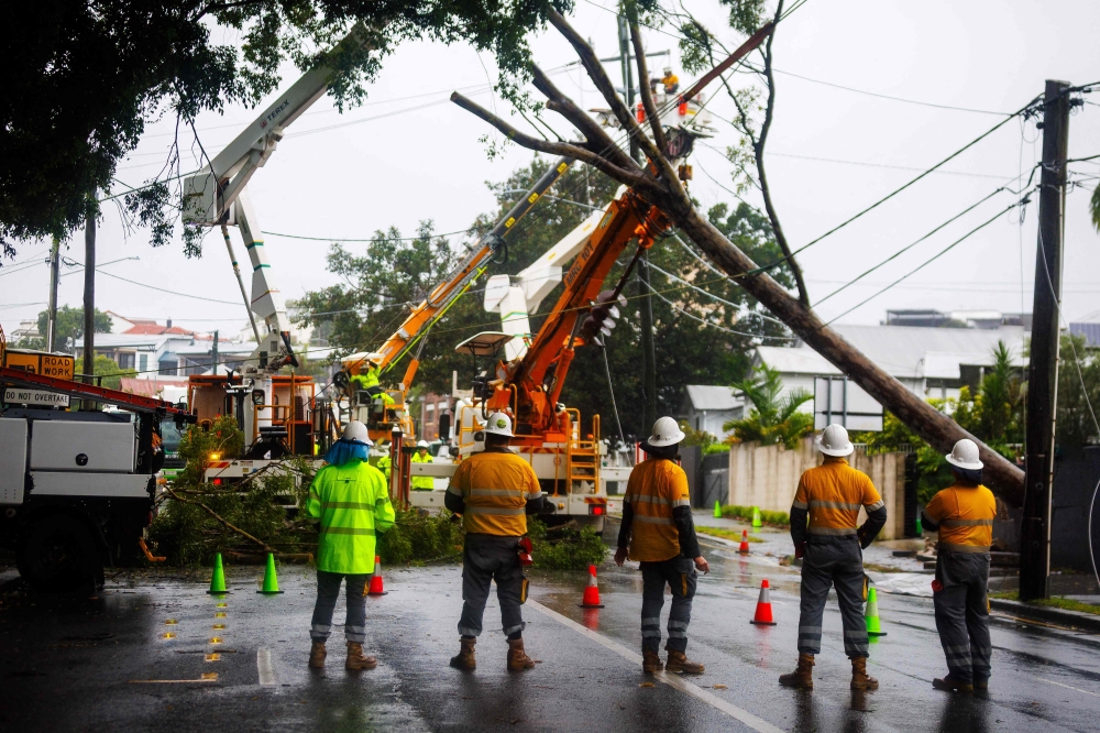 Energex crews clear a fallen tree following the passage of tropical cyclone Alfred in Brisbane on March 8, 2025. Hundreds of thousands of people in Australia’s Queensland state were without power on Sunday after ex-tropical cyclone Alfred brought damaging winds and heavy rains, sparking flood warnings. — AFP pic 