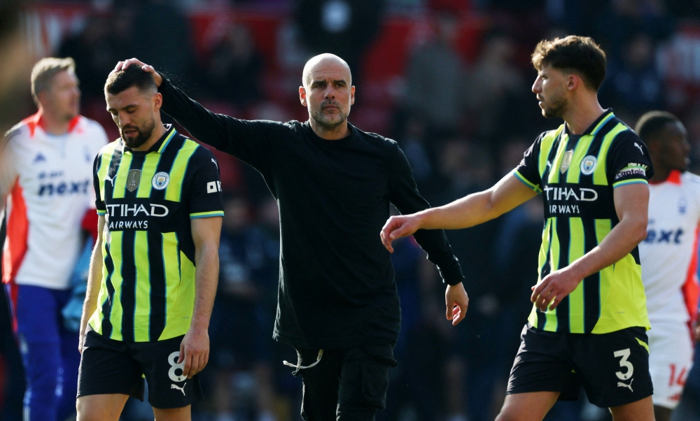 Manchester City’s Mateo Kovacic and manager Pep Guardiola look dejected after the match against Nottingham Forest at The City Ground, Nottingham, March 8, 2025. — Action Images pic via Reuters 