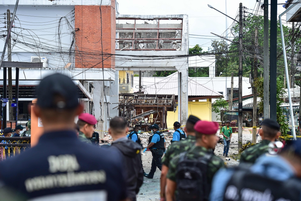 Thailand's forensic police officers (C) inspect the site of an attack that killed two defence volunteers and injured 12 others, outside the district office of Sungai Kolok in the southern Thailand province of Narathiwat on March 9, 2025. A low-level conflict has simmered in the country's southernmost provinces since 2004, killing more than 7,000 people, as rebels in the Muslim-majority region battle for greater autonomy from the state. — AFP pic