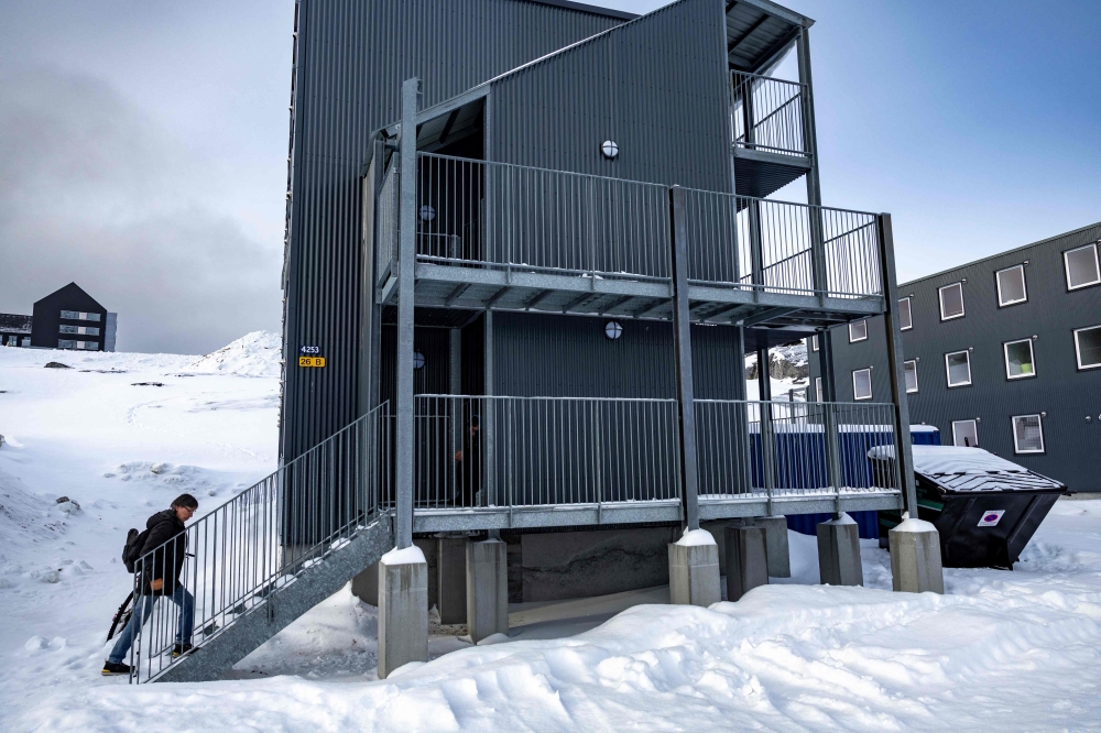 Residents are seen outside their temporary home in a container shelter in Nuuk, Greenland, on March 7, 2025. — AFP pic