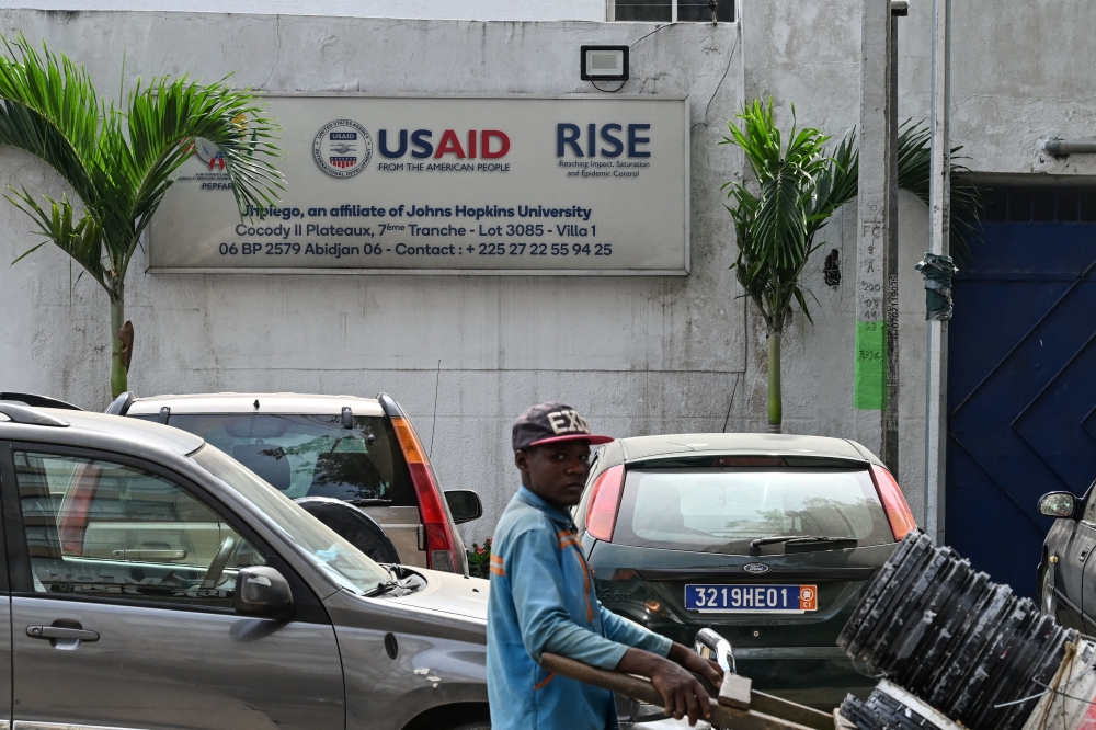 A man walks past a closed United States Agency for International Development (USAID) office in Abidjan on March 6, 2025. US Secretary of State Marco Rubio said Monday the United States was cancelling 83 per cent of programmes at USAID. — AFP pic 