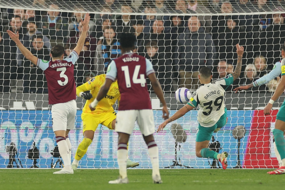 Newcastle United's Brazilian midfielder Bruno Guimaraes (right) scores the opening goal of the English Premier League football match with West Ham United at the London Stadium, in London on March 10, 2025. — AFP pic
