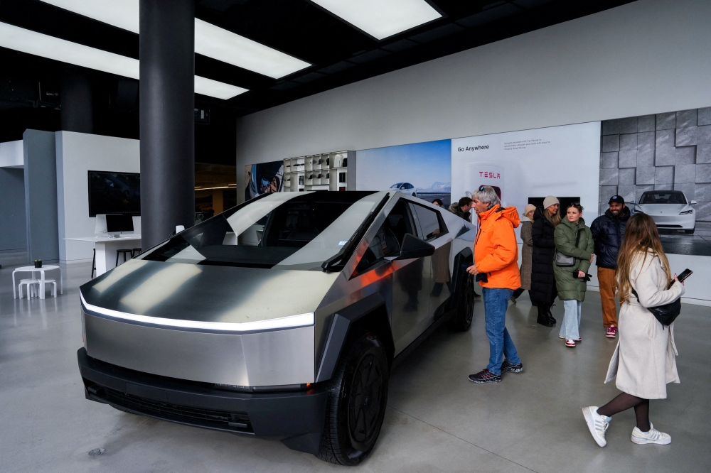 People look at a Tesla Cybertruck at a Tesla showroom in New York City, US January 2, 2025. — Reuters pic 