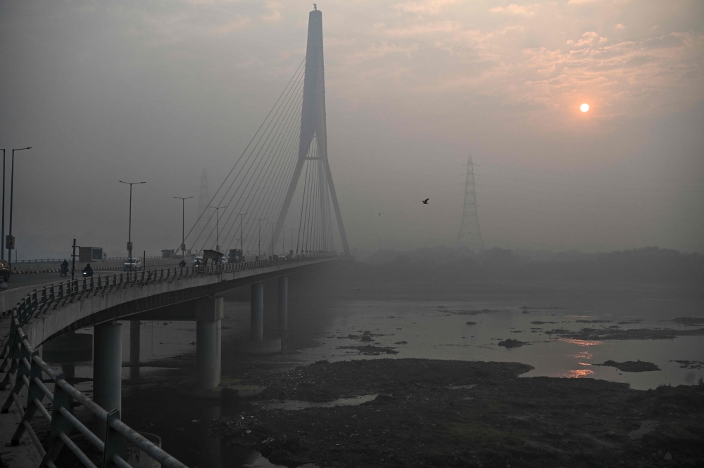A general view shows the Signature Bridge over the Yamuna River on a smoggy winter morning in New Delhi on December 20, 2024. Despite an improvement in 2024, India again dominated global rankings for the cities with the most dangerous particle smog while Chad was the most polluted country, according to a report published on March 11, 2025. — AFP pic 
