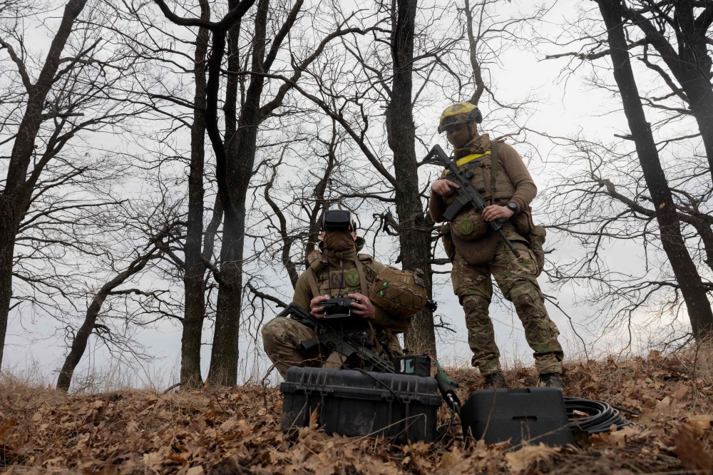 Ukrainian servicemen of the 3rd Operational Assignment Spartan Brigade navigate a drone during its flight as part of a military training in Dnipropetrovsk Region on March 10, 2025. — AFP pic