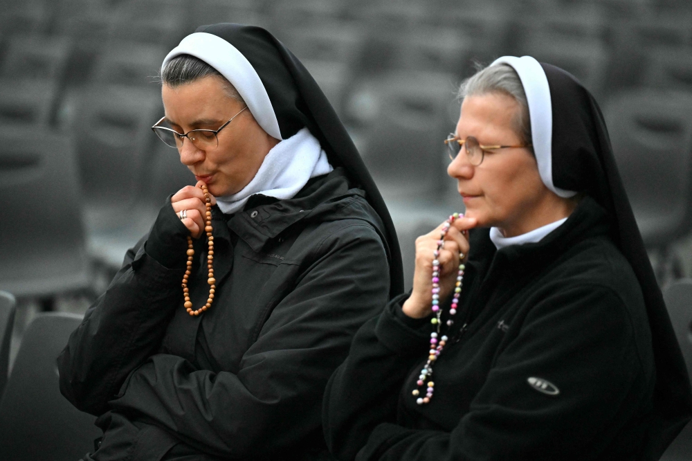 Nuns attend rosary prayers for Pope Francis who is still hospitalised with pneumonia, in The Vatican on March 10, 2025. — AFP pic