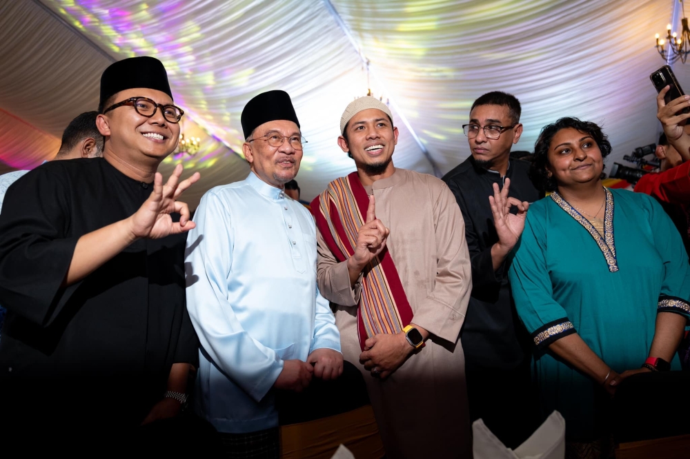 Prime Minister Datuk Seri Anwar Ibrahim poses for pictures with Era FM hosts Nabil Ahmad, Radin Amir Affendy and Azad Jazmin during the Prime Minister’s Iftar with Media Practitioners event in Kuala Lumpur March 11, 2025. — Picture via Facebook/Anwar Ibrahim