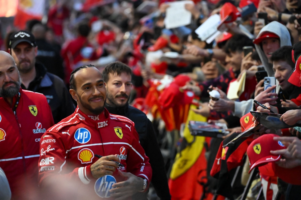 British F1 driver Lewis Hamilton signs autographs during the Scuderia Ferrari HP Drivers' presentation event by Unicredit, in Piazza Castello in Milan, on March 6. — AFP pic