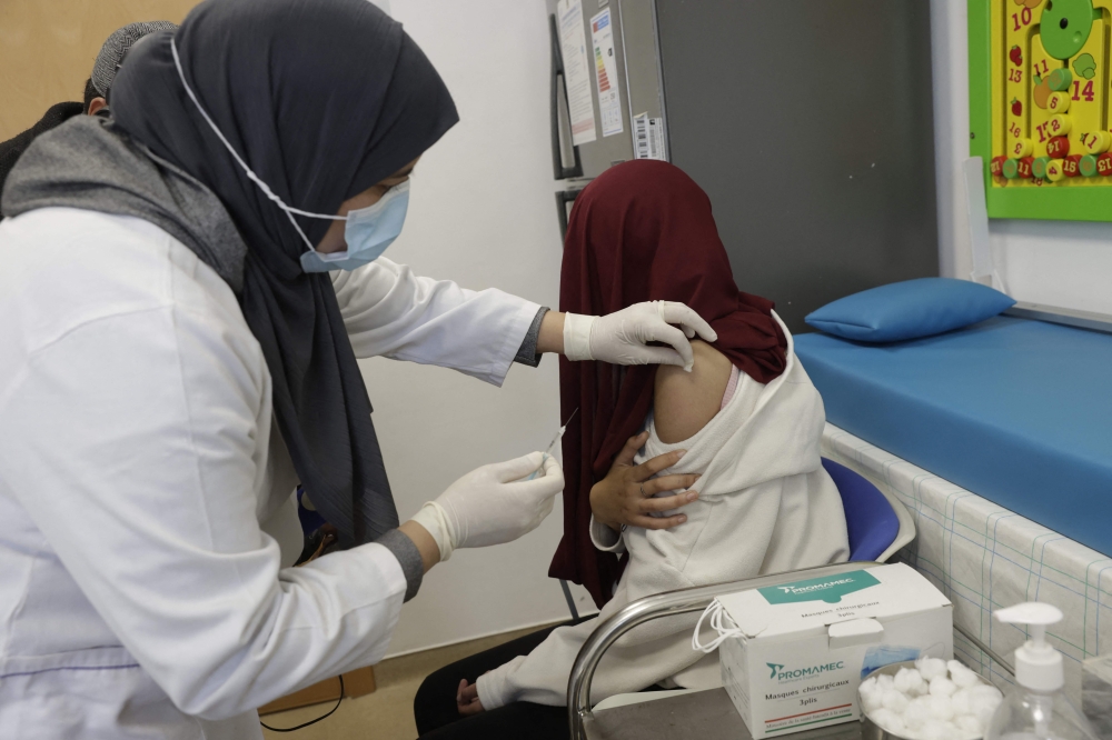A woman receives a doze of measles vaccine at a hospital in the Moroccan coastal city of Temara on February 27. — AFP pic