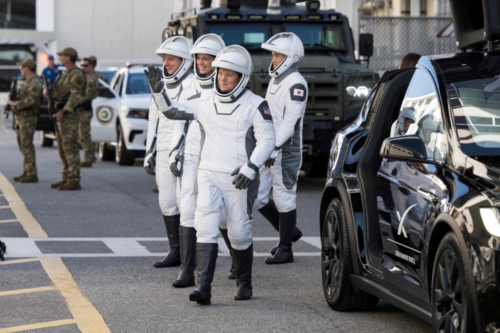 NASA astronauts Anne McClain and Nichole Ayers, JAXA (Japan Aerospace Exploration Agency) astronaut Takuya Onishi, and Roscosmos cosmonaut Kirill Peskov, wearing SpaceX spacesuits, are seen as they prepare to depart the Neil  A. Armstrong Operations and Checkout Building for Launch Complex 39A on NASA's Kennedy Space Center to board the SpaceX Dragon spacecraft for the Crew-10 mission launch yesterday. — AFP pic