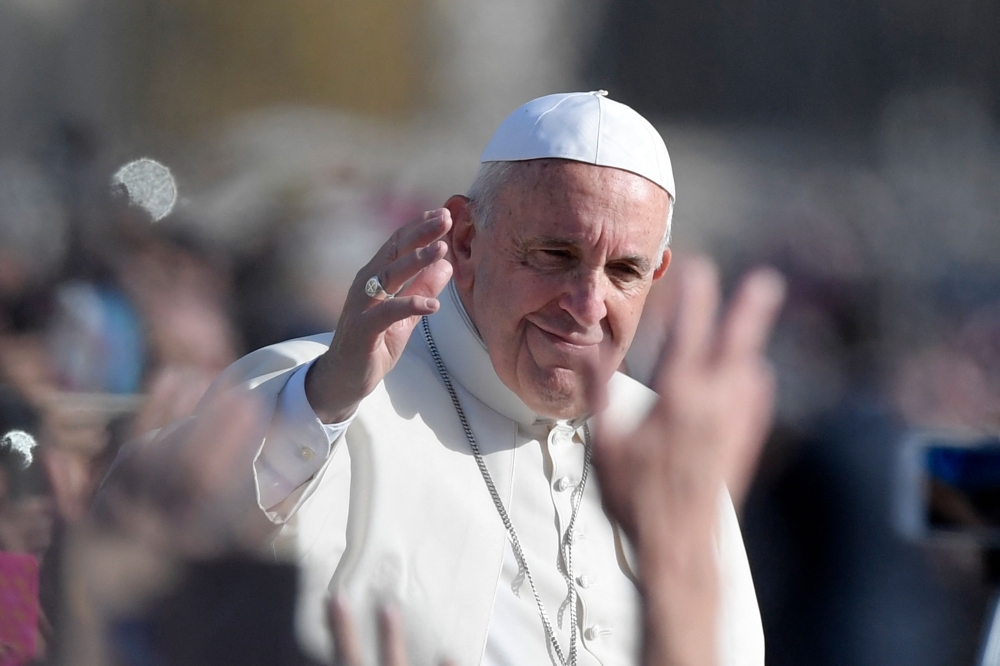 Pope Francis greets the crowd from the popemobile after the celebration of a mass marking the end of the Jubilee of Mercy, on November 20, 2016 in Vatican. — File pic via AFP