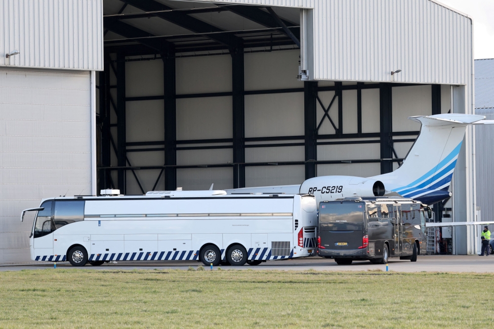 A prison bus parks next to an aircraft carrying former Philippine President Rodrigo Duterte after its arrival at Rotterdam The Hague Airport. — Reuters pic