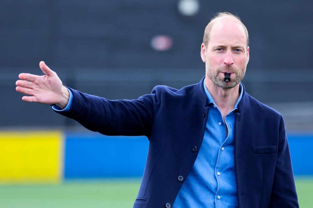 The Prince Of Britain's Prince William, Prince of Wales lows the referee's whistle during a mini football game as part of his visit to the FA Referee Training Course, at the Aspray Arena, in Willenhall, England, on on March 11, 2025. — AFP pic