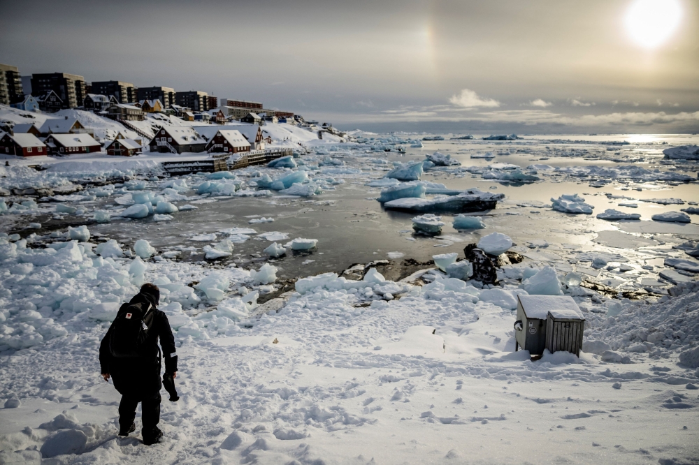 A person walks on ice in a fjord near Nuuk, Greenland, March 7, 2025. — Reuters pic