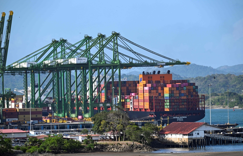 A cargo ship waits at Balboa port before crossing the Panama Canal in Panama City on February 4. — AFP pic