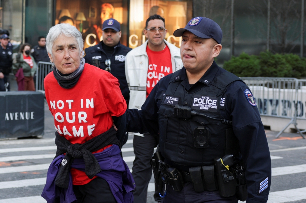 Police officers detain protesters during a rally against the ICE detention of Palestinian activist and Columbia University graduate student Mahmoud Khalil, at Trump Tower in New York March 13, 2025. — Reuters pic