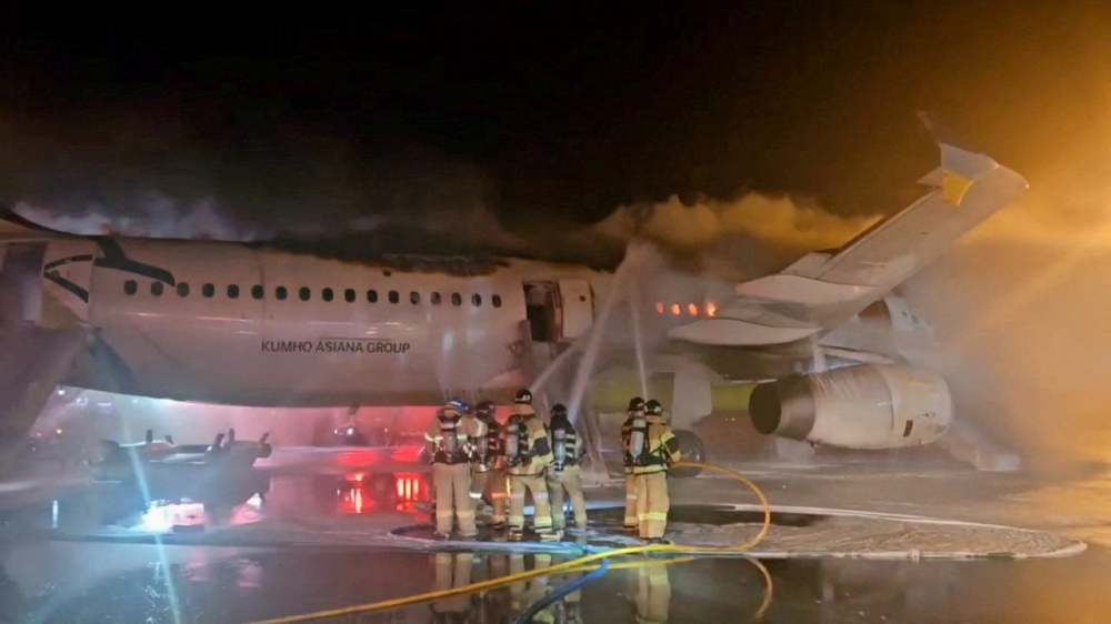 Firefighters try to put out the fire from an Air Busan plane at Gimhae International Airport in Busan January 28, 2025. — Reuters pic