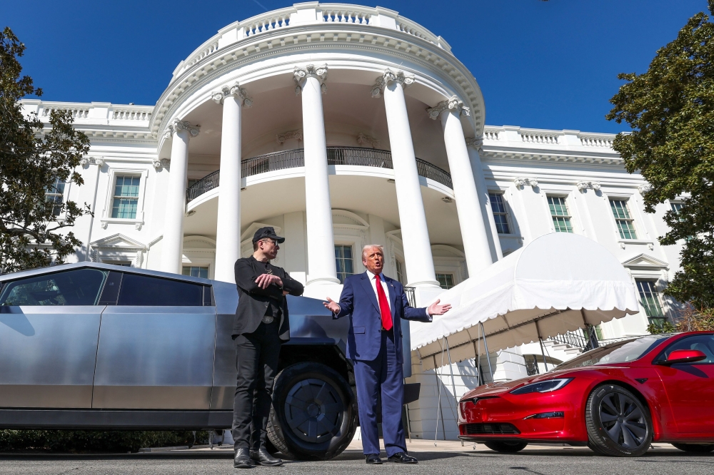 U.S. President Donald Trump talks to the media next to Tesla CEO Elon Musk, with Tesla cars in the background, at the White House in Washington, D.C., U.S., March 11, 2025. — Reuters pic
