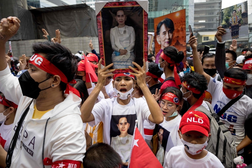 Protesters hold images of detained civilian leader Aung San Suu Kyi during a demonstration outside the Embassy of Myanmar in Bangkok February 1, 2023, to mark the second anniversary of the coup in Myanmar. More than a million people have fled Myanmar’s brutal civil war to seek shelter and work in neighbouring Thailand, where experts say nationalists are using disinformation to fuel prejudice against them in the ‘Land of Smiles’. — AFP pic