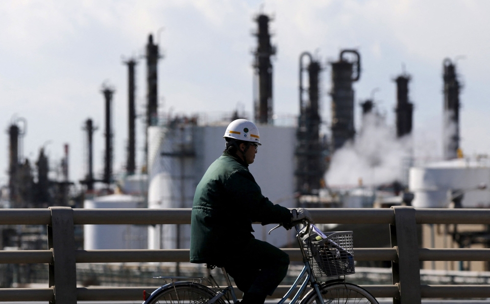 File picture of a worker cycling near a factory at the Keihin industrial zone in Kawasaki, Japan February 17, 2016. Japanese companies have agreed to raise wages by more than 5 per cent for a second year in a row this year, the country’s largest union umbrella group said on Friday. — Reuters pic 