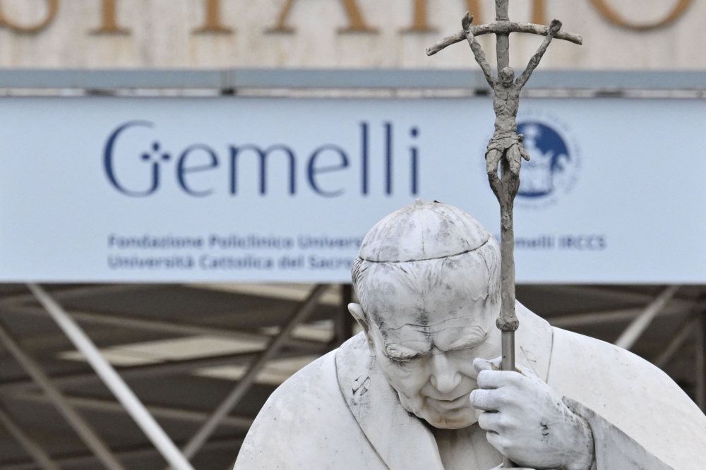 This picture shows the statue of John Paul II at the entrance of the Gemelli University Hospital where Pope Francis is hospitalised. — AFP pic
