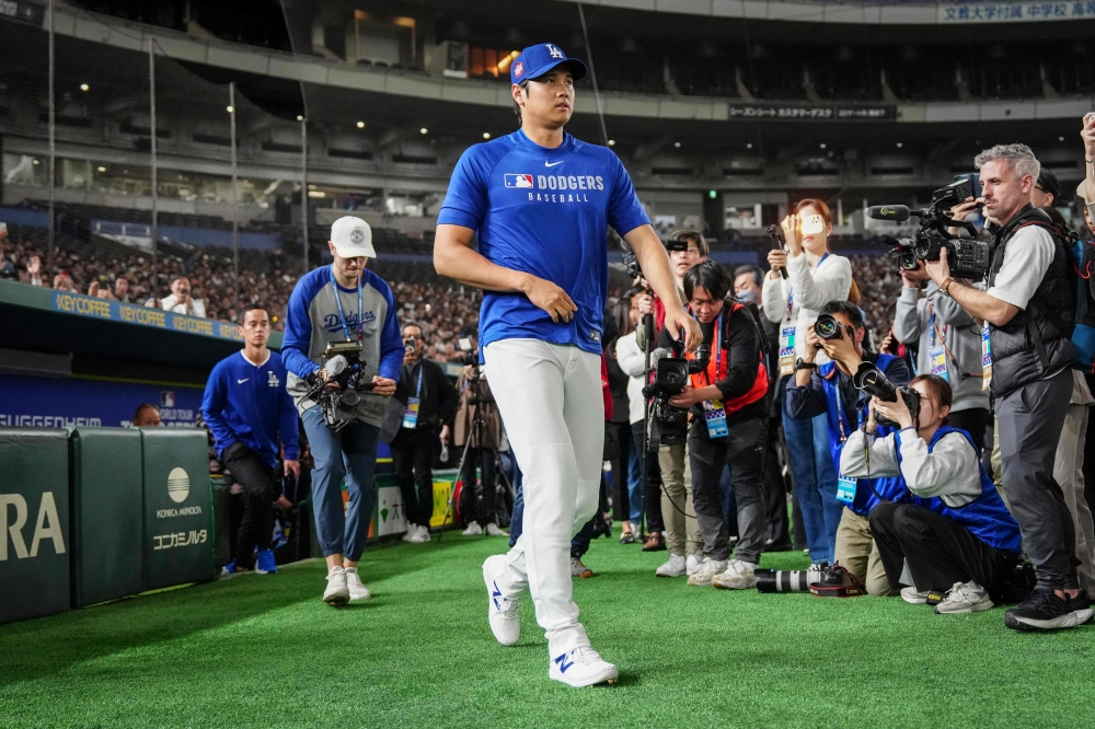 Thousands of paying fans in Tokyo clapped and cheered as they watched Shohei Ohtani arrives for a training session ahead of the Major League Baseball season-opener. — AFP pic