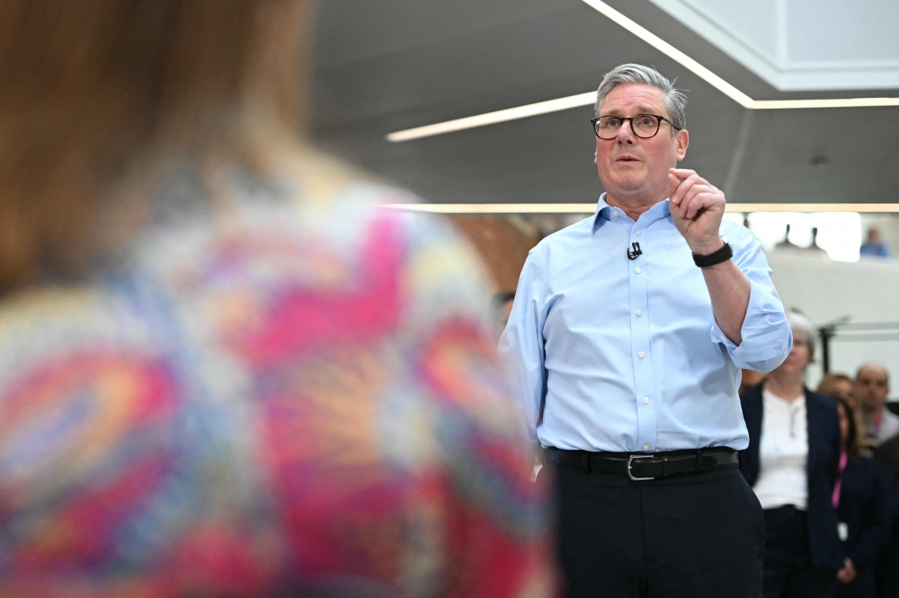 Britain's Prime Minister Keir Starmer gestures during a Q&A session after delivering a speech on plans to reform the civil service, during a visit to Reckitt Benckiser Health Care UK Ltd in Kingston upon Hull, north-east England on March 13, 2025. — AFP pic