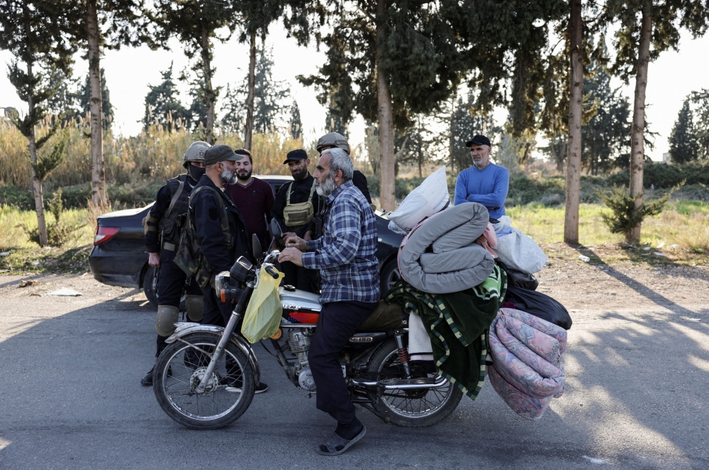 A Syrian man carries mattress on a motorcycle, in Latakia, Syria March 13, 2025. — Reuters pic