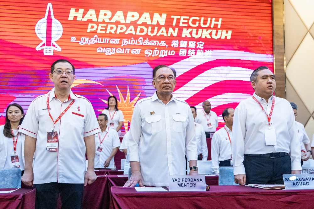 (From left) DAP national chairman Lim Guan Eng, Prime Minister Datuk Seri Anwar Ibrahim and DAP secretary-general Anthony Loke attend the 18th DAP National Congress at Ideal Convention Centre (IDCC) in Shah Alam March 16, 2025. — Picture by Firdaus Latif