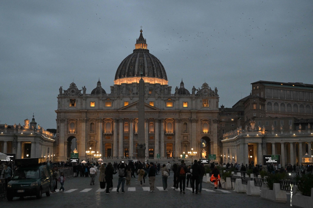 A picture shows the lights of St Peter's basilica in The Vatican on March 14, 2025. — AFP pic