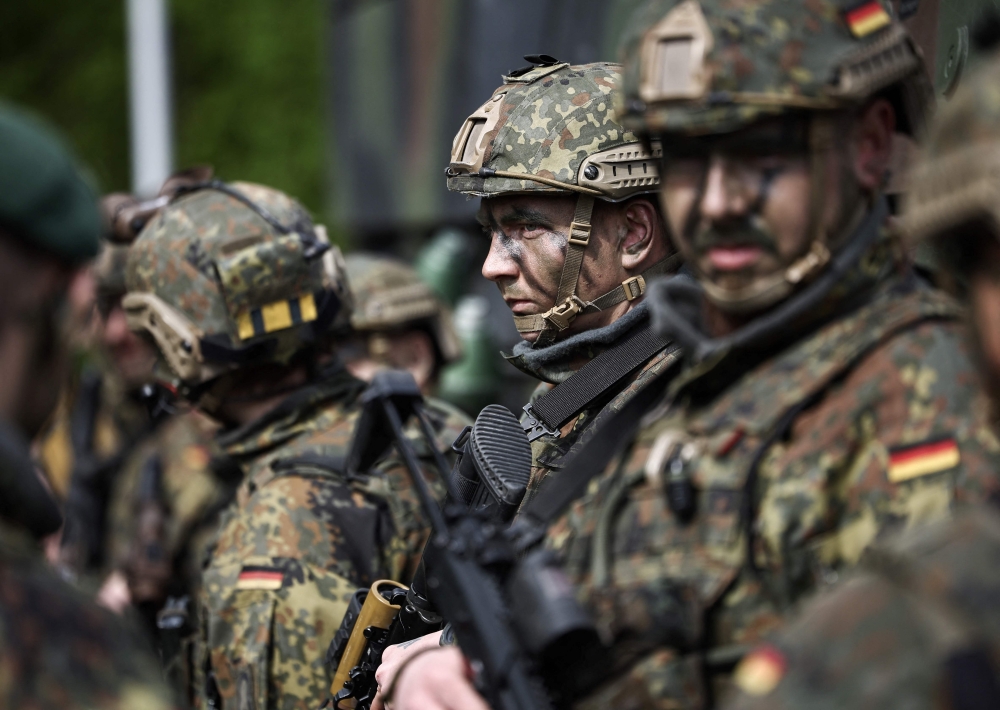 In this file photo taken on April 24, 2024 German soldiers stand in front of a Boxer military vehicle, a new type of armoured personnel carrier, at the Julius Leber Barracks in Berlin. — AFP file pic