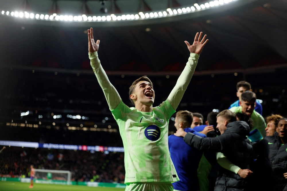 Barcelona's Spanish midfielder Pablo Gavi celebrates the victory at the end of the Spanish league football match against Atletico Madrid yesterday. — AFP pic