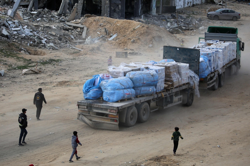A truck loaded with humanitarian aid drives through Rafah in the southern Gaza Strip after entering from the Kerem Shalom crossing on February 18, 2025. — AFP pic